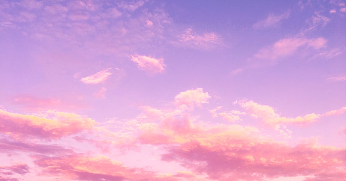 A dreamy pink and purple cloud-filled sky at sunset, creating a serene and tranquil atmosphere.